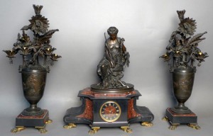 Antique patinated bronze and Belgian marble figural garniture mantel clock and candelabra set, est. $5,000-$7,000. Sterling Associates image
